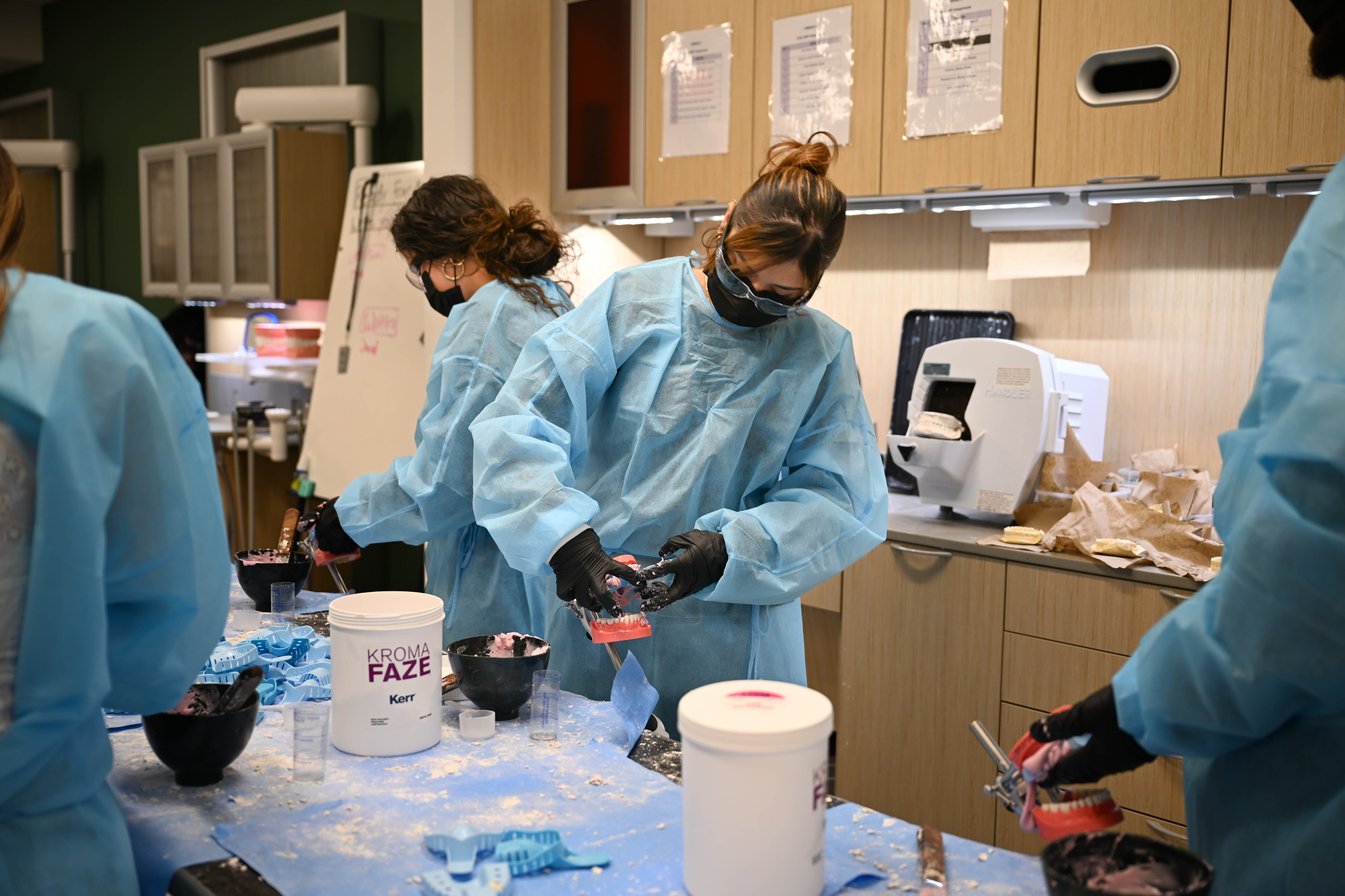 Group of dental assistant students working on a teeth mold
